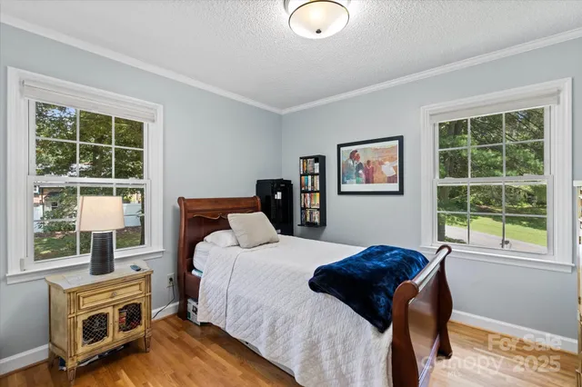 a bathroom with a granite countertop sink a mirror and shower