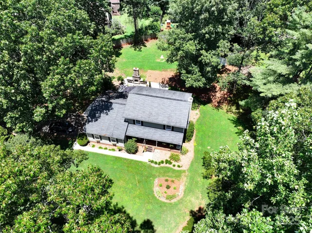 an aerial view of a house with a yard