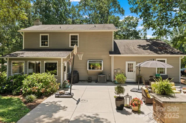 a view of an outdoor sitting area with furniture and umbrella