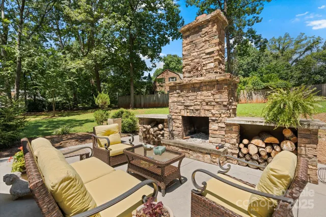 swimming pool with outdoor seating and green space