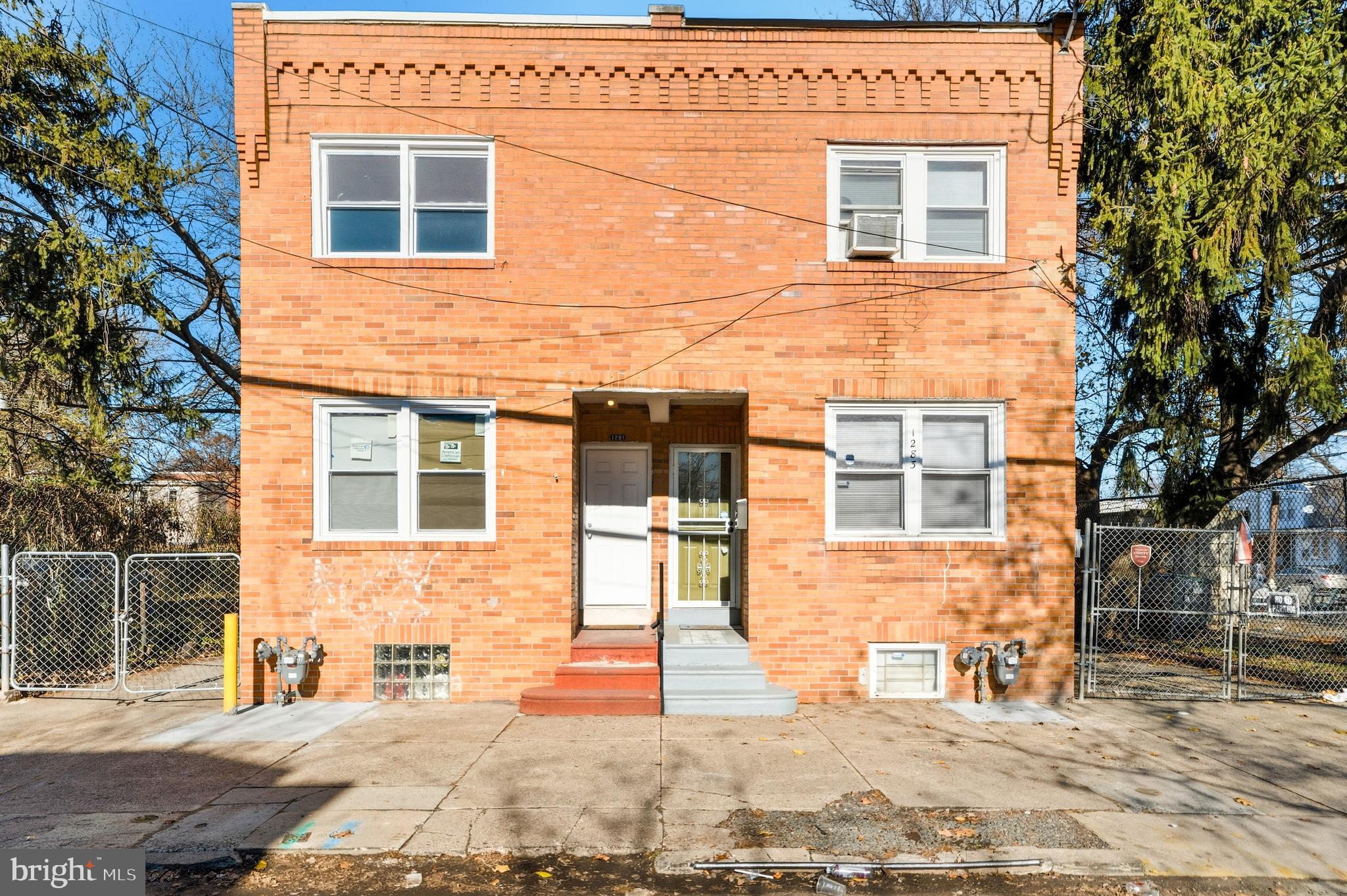 a view of a brick house with many windows