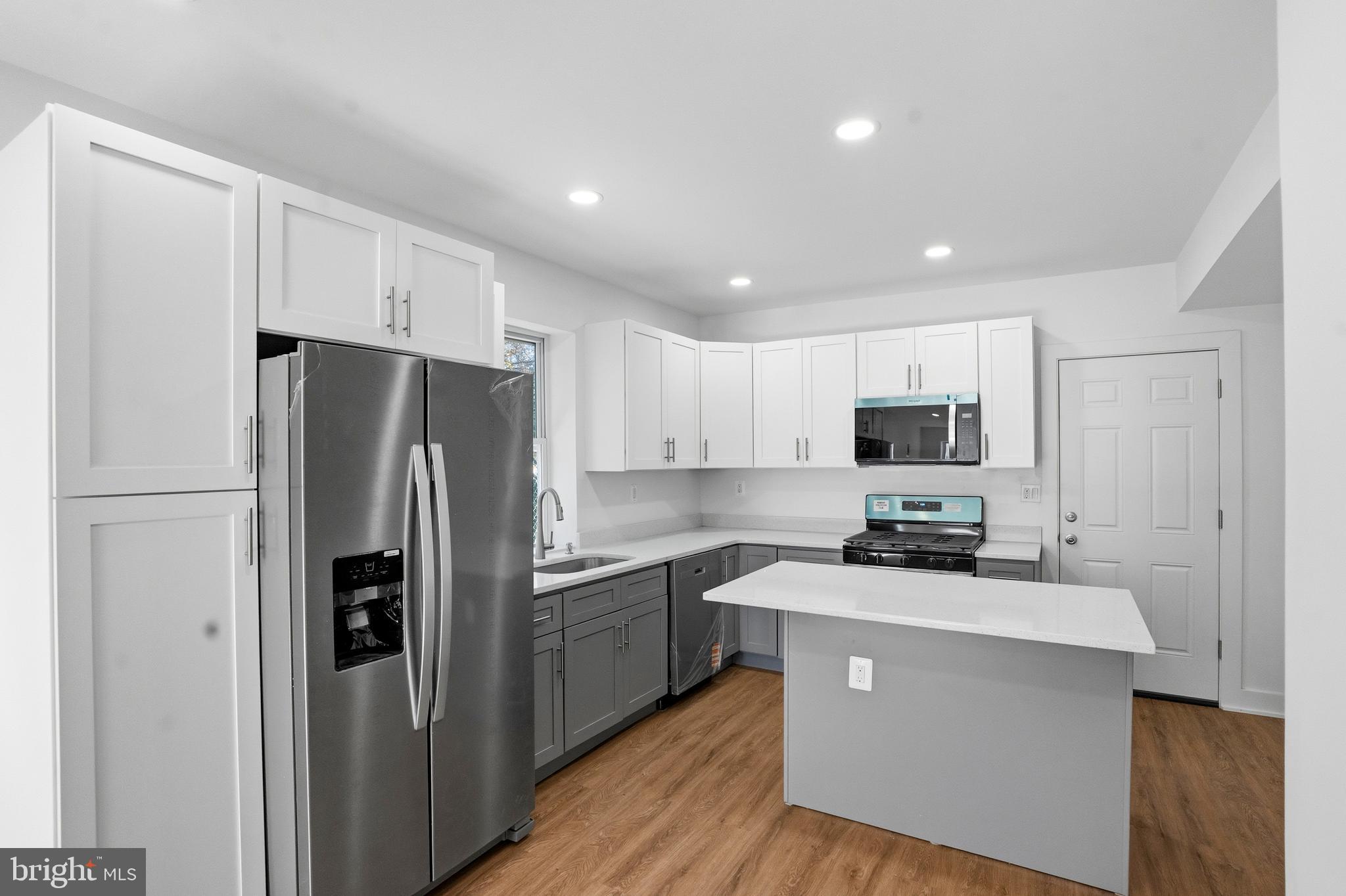 1281 Jackson Street Camden, NJ 08104 - Photo 11 of 43 a kitchen with stainless steel appliances a refrigerator sink and microwave