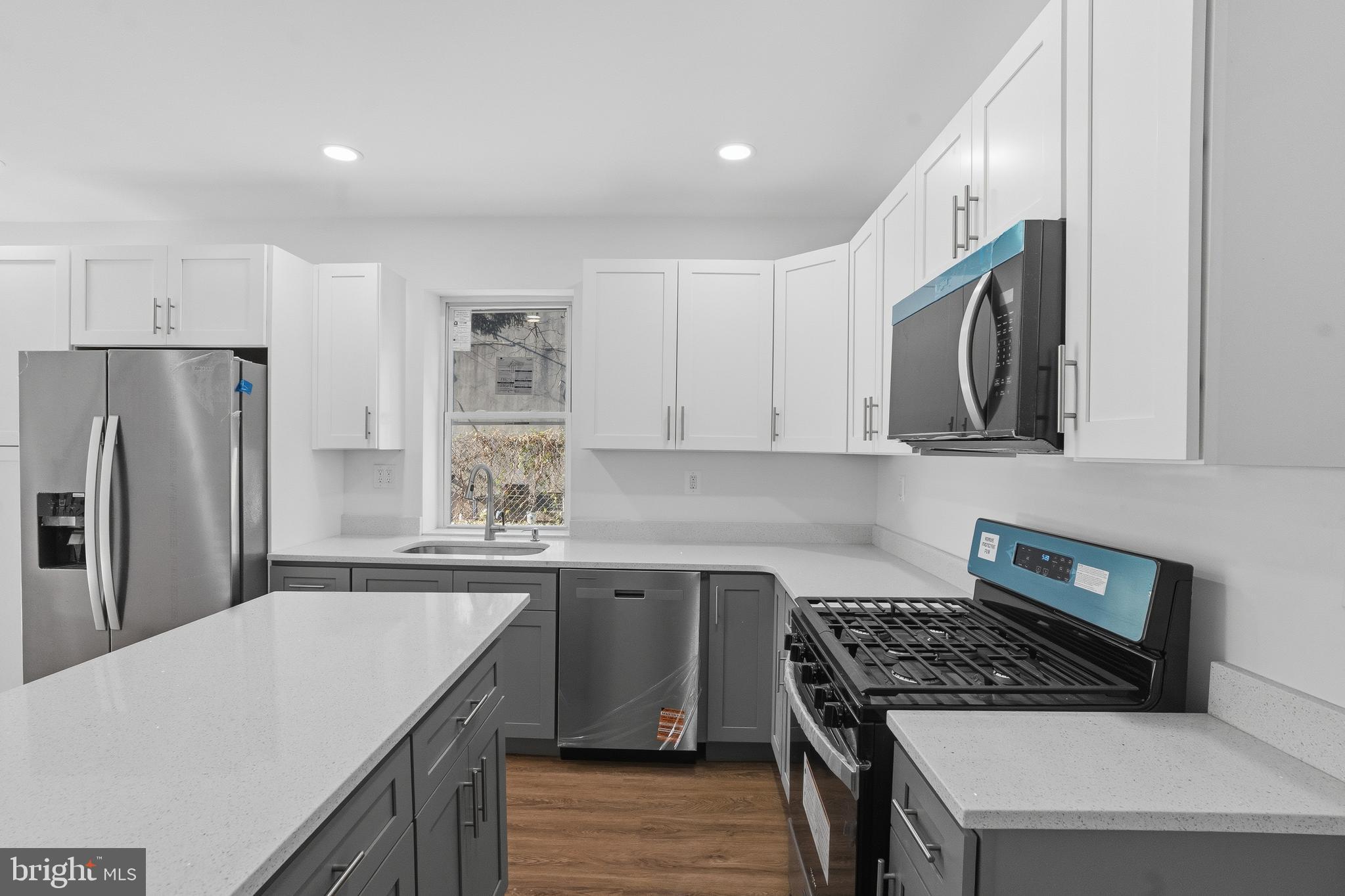 1281 Jackson Street Camden, NJ 08104 - Photo 13 of 43 a kitchen with stainless steel appliances granite countertop a sink stove and refrigerator