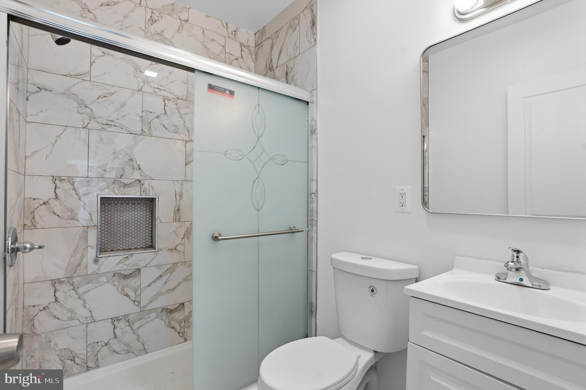 1281 Jackson Street Camden, NJ 08104 - Photo 16 of 43 a bathroom with a sink a toilet and shower