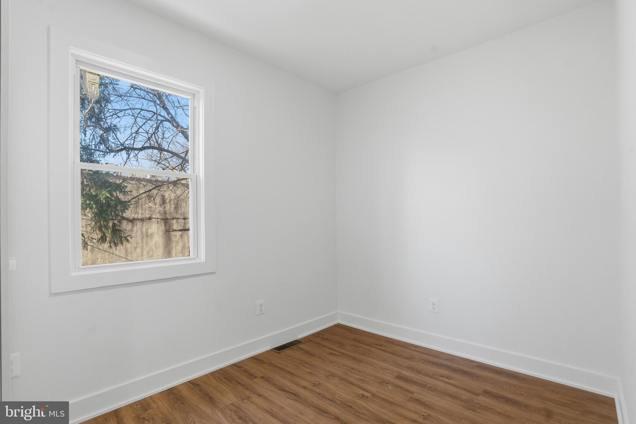 1281 Jackson Street Camden, NJ 08104 - Photo 27 of 43 a view of a small space with wooden floor and a window