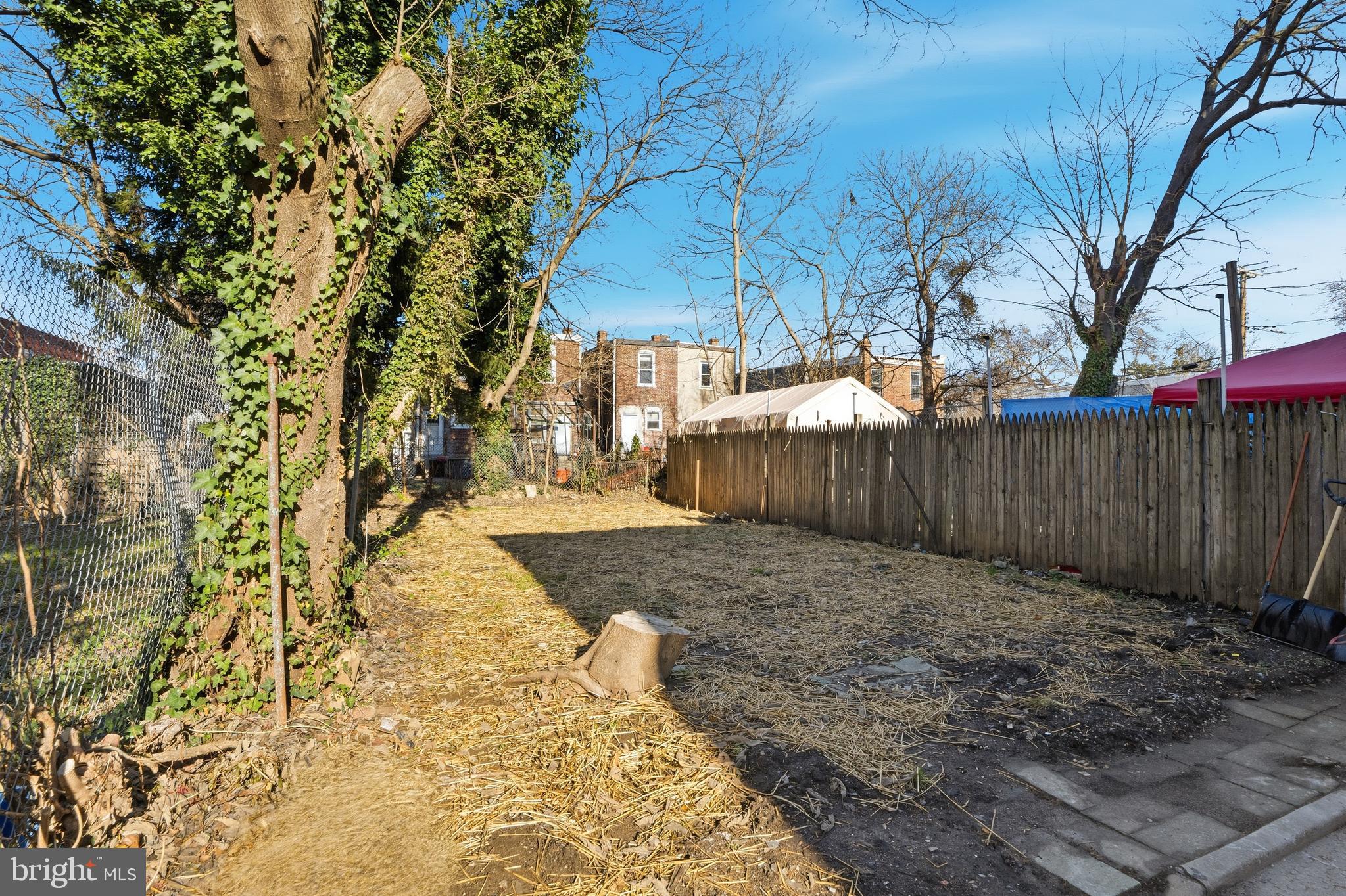 1281 Jackson Street Camden, NJ 08104 - Photo 33 of 43 a view of a backyard with trees and wooden fence