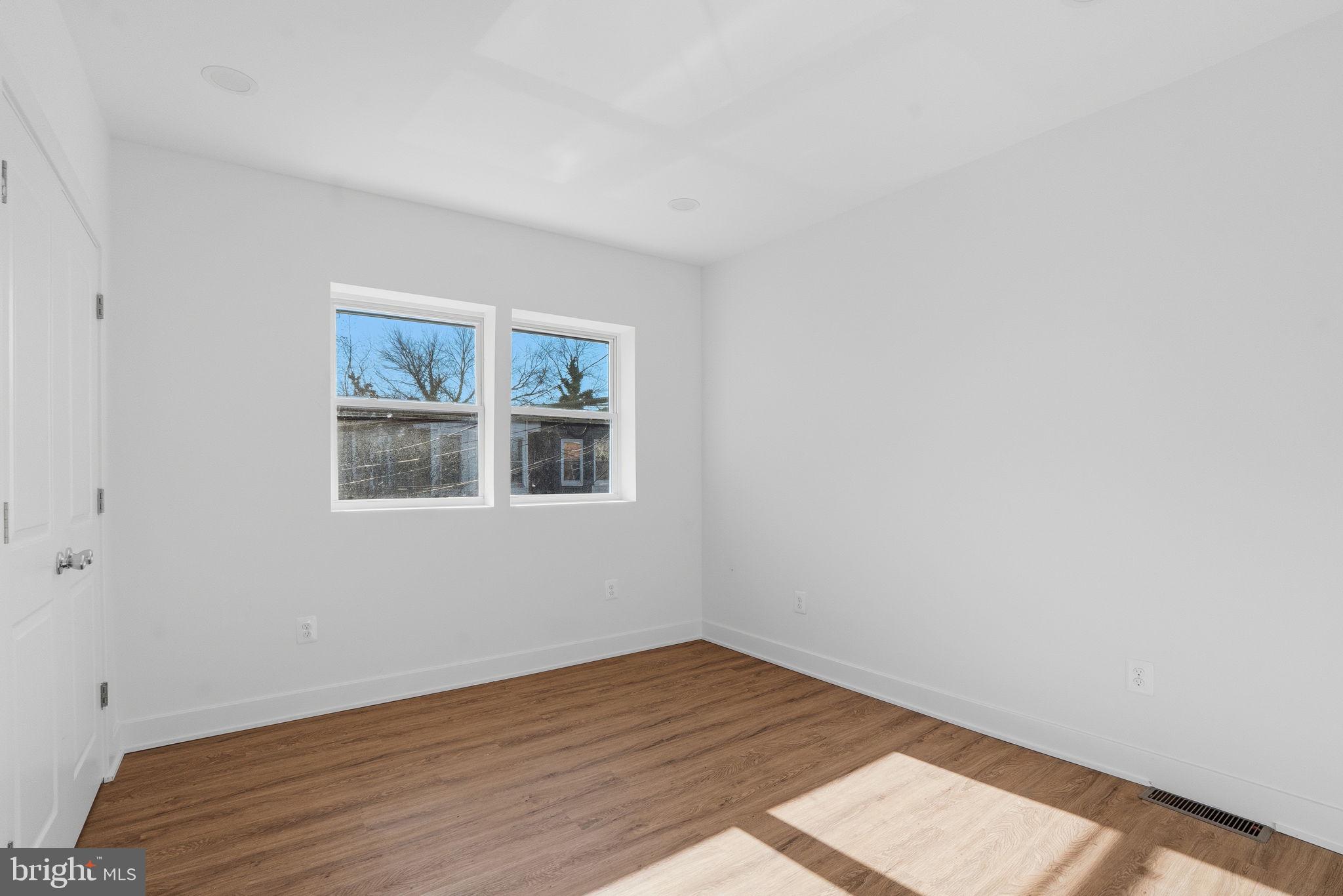 1281 Jackson Street Camden, NJ 08104 - Photo 5 of 43 a view of an empty room with wooden floor and a window
