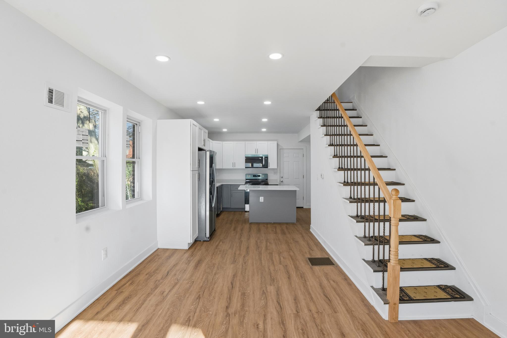 1281 Jackson Street Camden, NJ 08104 - Photo 9 of 43 a view of a kitchen with wooden floor electronic appliances and stairs