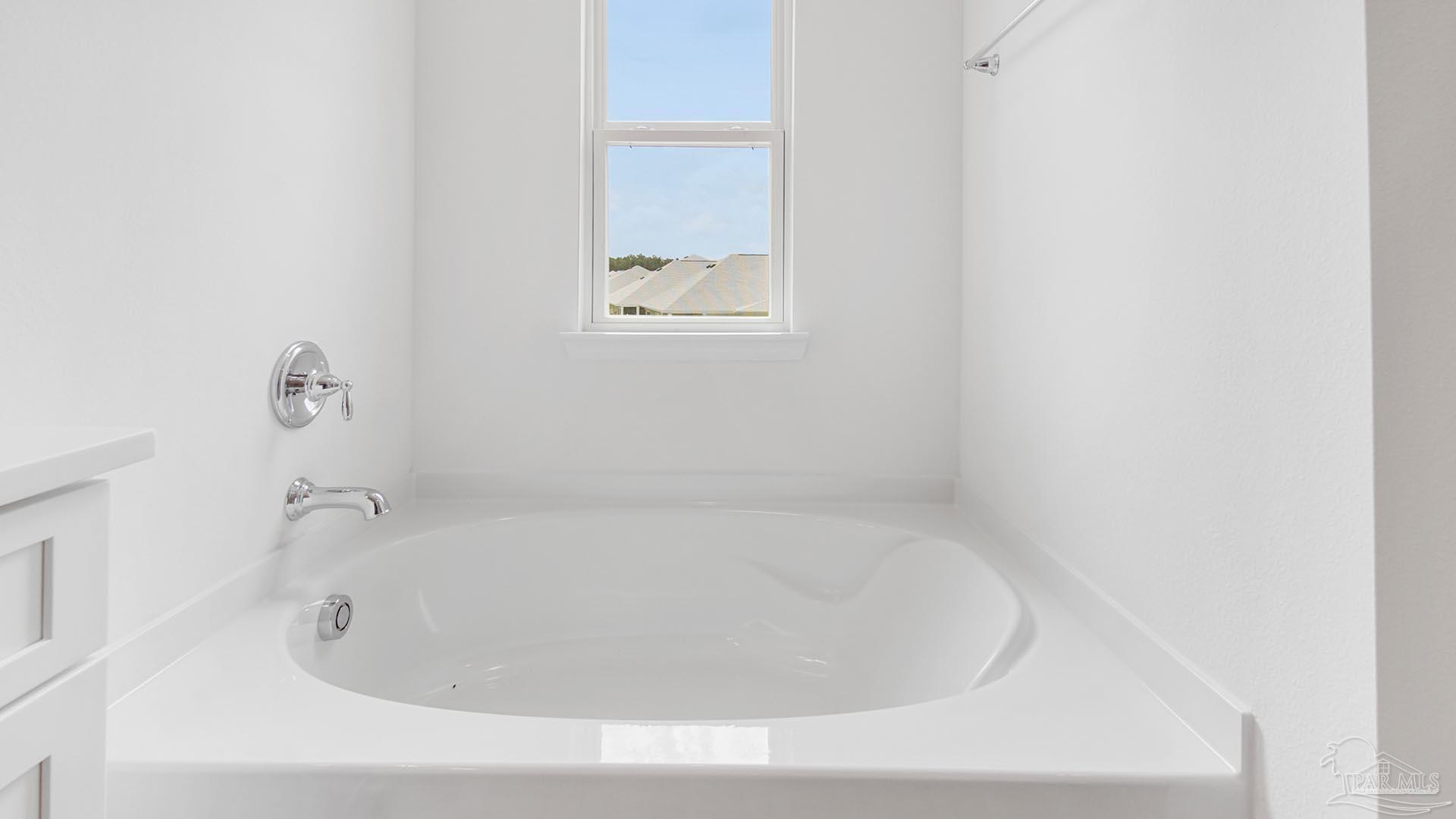 3233 Harrier Road Pace, FL 32571 - Photo 16 of 50 a white bath tub sitting in a bathroom