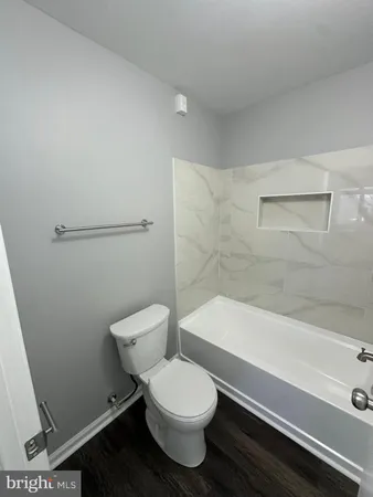 a bathroom with a bathtub and shower