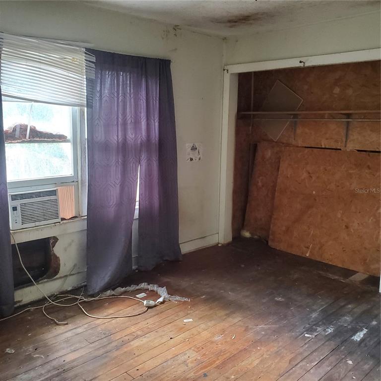 949 North Lake Street Lake Hamilton, FL 33844 - Photo 9 of 11 an empty room with wooden floor and windows