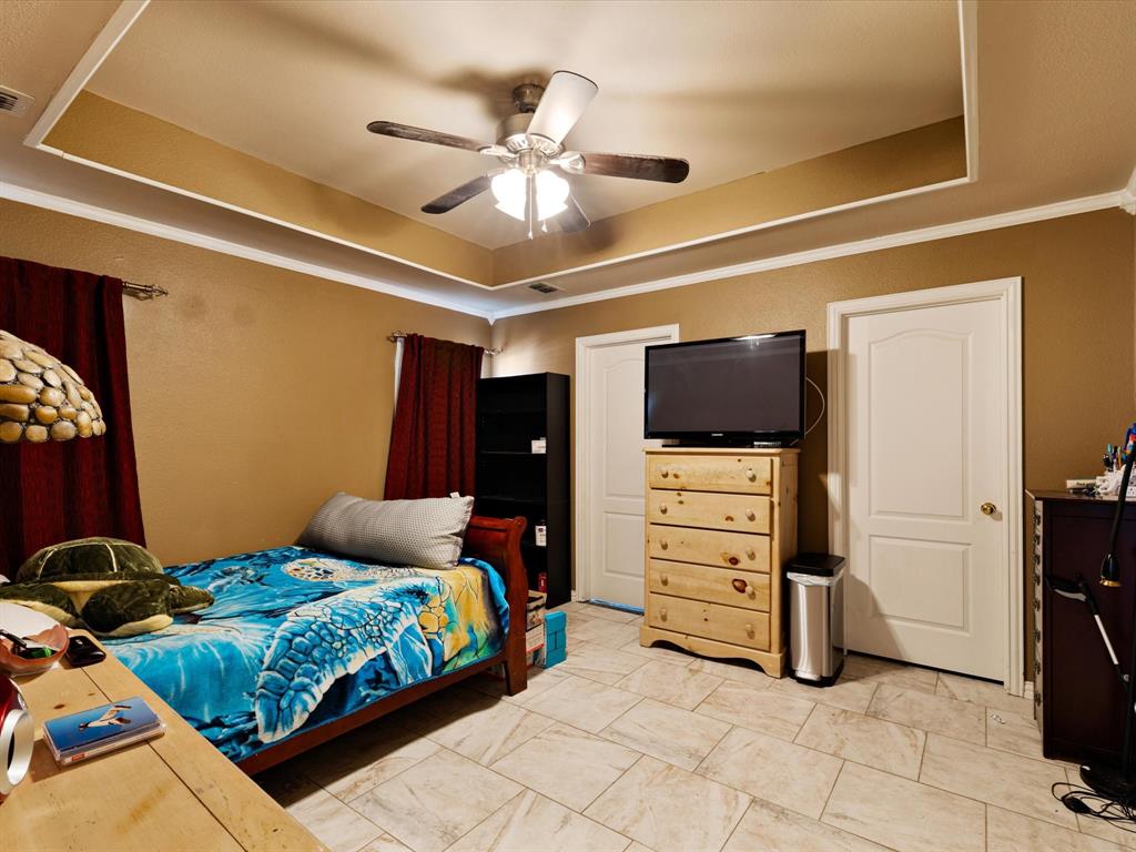 207 Quail Run Aubrey, TX 76227 - Photo 14 of 30 Bedroom with a raised ceiling, crown molding, and a ceiling fan