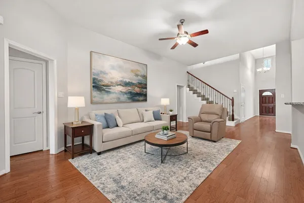 a living room with furniture and wooden floor