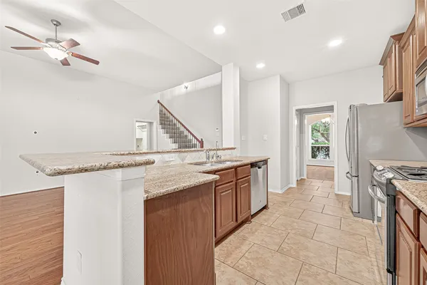 a kitchen with stainless steel appliances granite countertop a stove and a sink