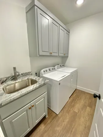 a utility room with a sink a washer and dryer