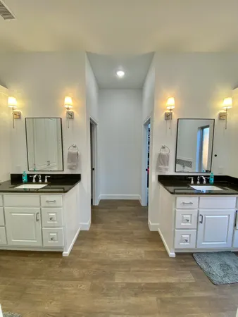 a kitchen with granite countertop a sink a stove top oven and cabinets