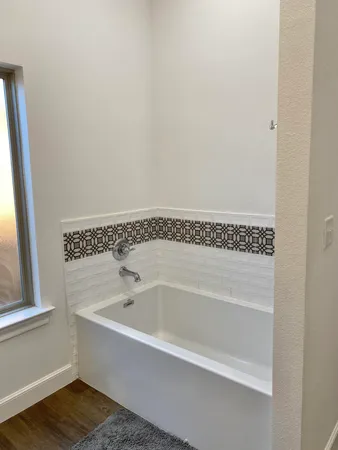 a white bath tub sitting next to a window
