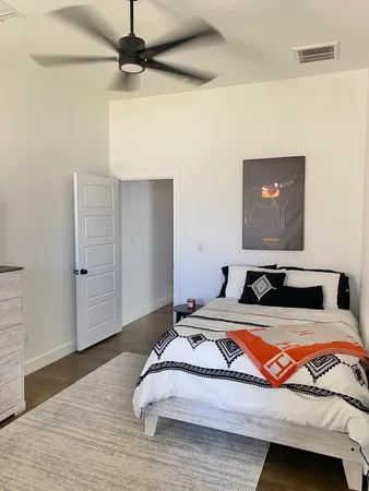 a bedroom with a bed and a flat screen tv