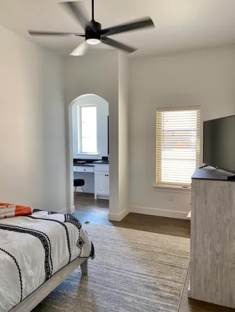 a bedroom with a bed and a chandelier