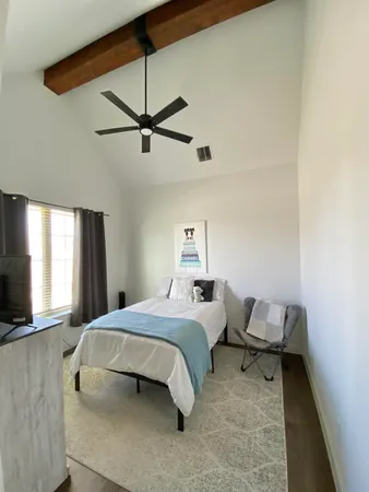 a bathroom with a granite countertop sink and a toilet