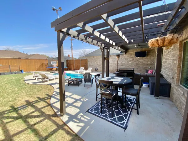 a view of a backyard with chair and door