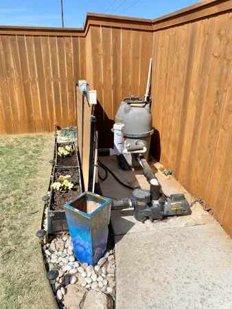 a backyard of a house with table and chairs