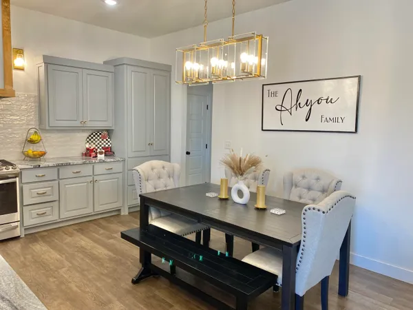 a outdoor dining room with furniture and chandelier