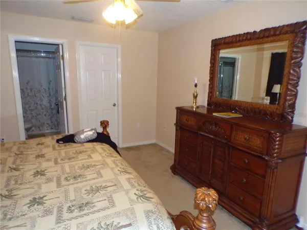 a bedroom with a bed and a dresser