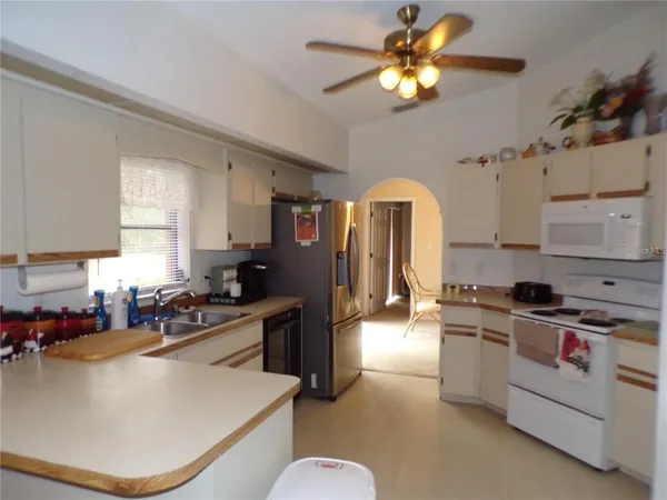 a kitchen with a stove a sink and a refrigerator