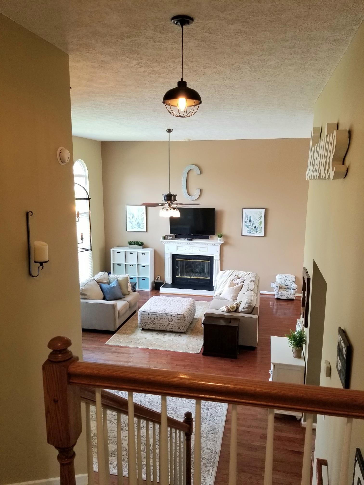 5249 Ridgefalls Way Antioch, TN 37013 - Photo 16 of 23 a living room with furniture a fireplace and a flat screen tv