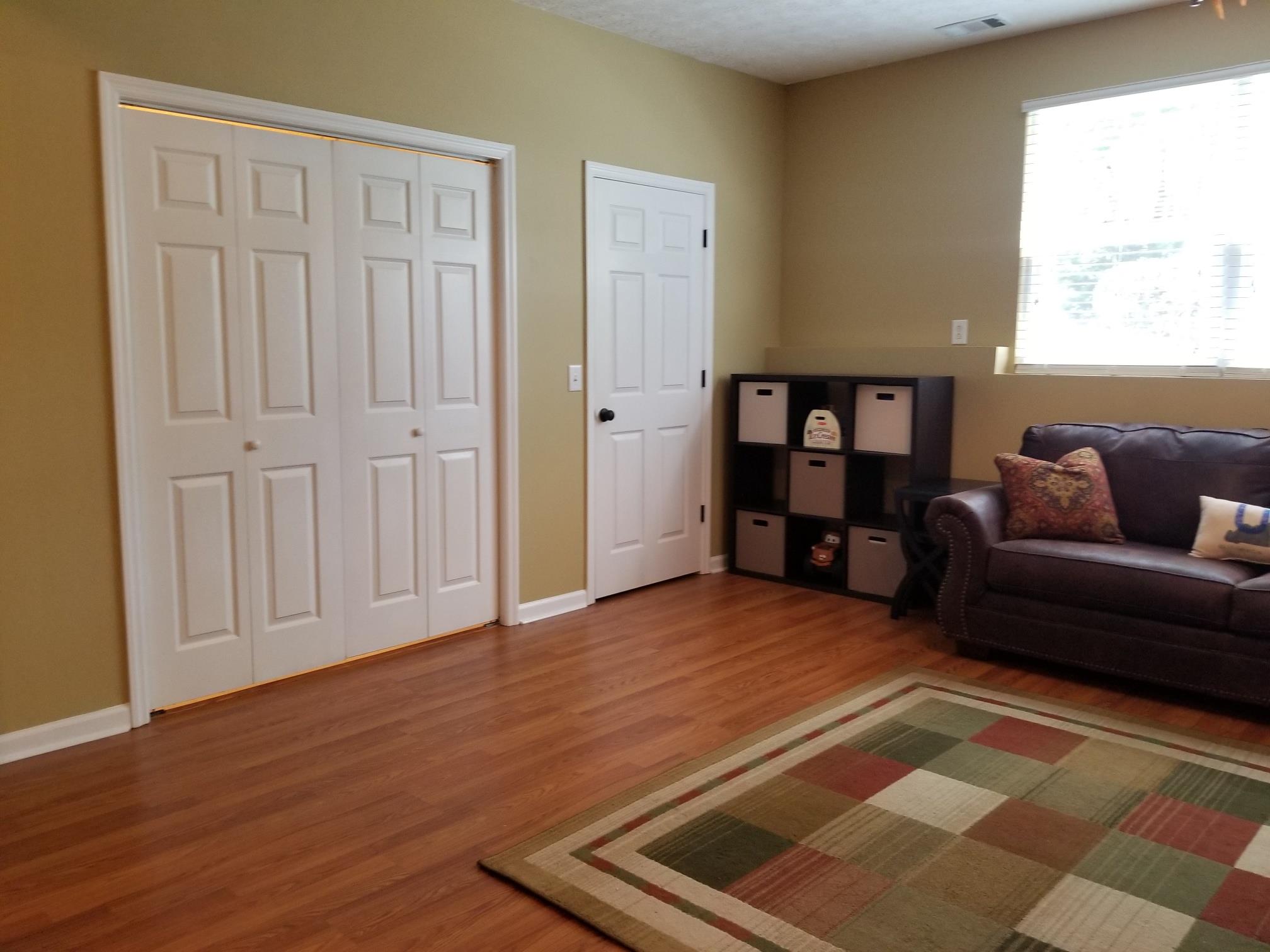 5249 Ridgefalls Way Antioch, TN 37013 - Photo 17 of 23 a living room with furniture and a book shelf