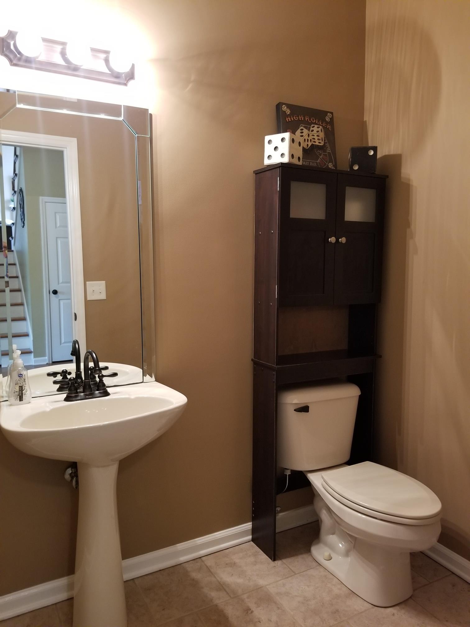 5249 Ridgefalls Way Antioch, TN 37013 - Photo 20 of 23 a bathroom with a toilet sink and mirror
