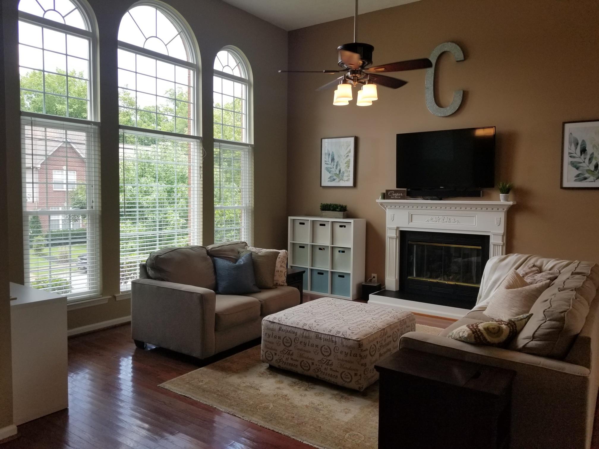 5249 Ridgefalls Way Antioch, TN 37013 - Photo 3 of 23 a living room with furniture a fireplace and a flat screen tv