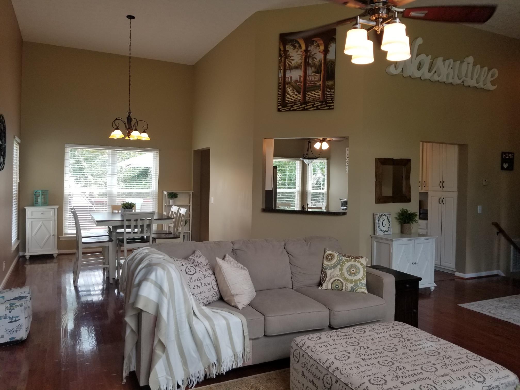 5249 Ridgefalls Way Antioch, TN 37013 - Photo 4 of 23 a living room with furniture a chandelier and a flat screen tv