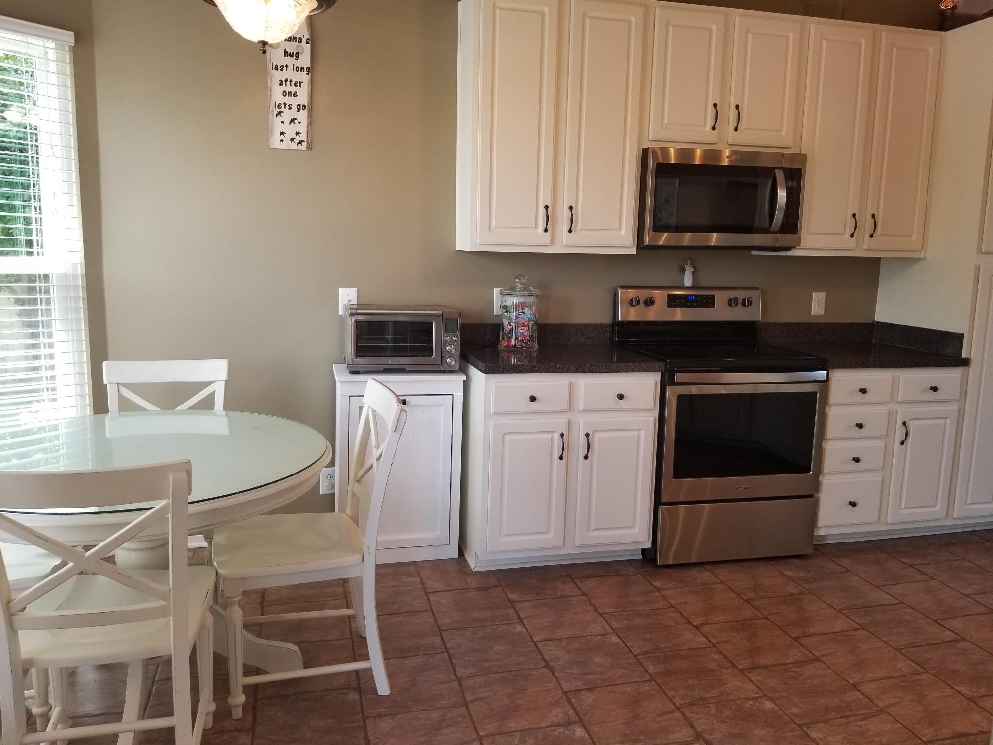 5249 Ridgefalls Way Antioch, TN 37013 - Photo 5 of 23 a kitchen with stainless steel appliances granite countertop a stove a sink and white cabinets