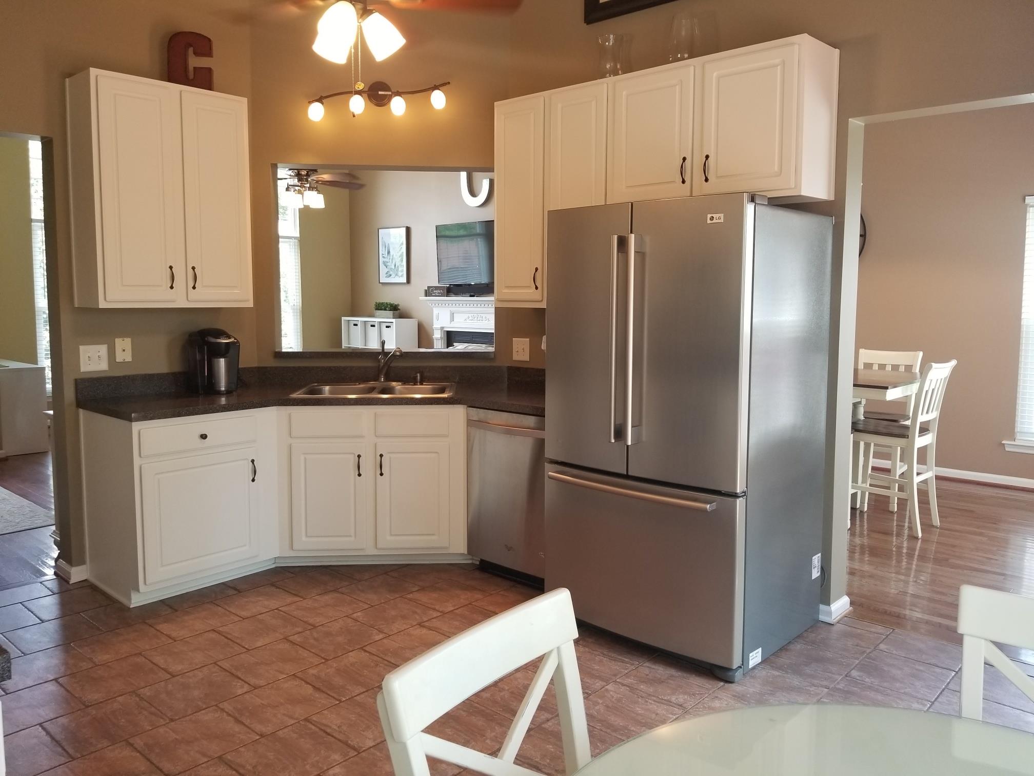 5249 Ridgefalls Way Antioch, TN 37013 - Photo 7 of 23 a kitchen with a refrigerator sink and cabinets