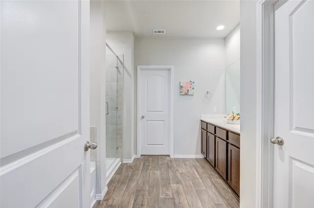 a view of a hallway with wooden floor and entryway