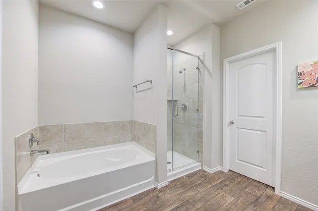 a bathroom with a bathtub and a shower