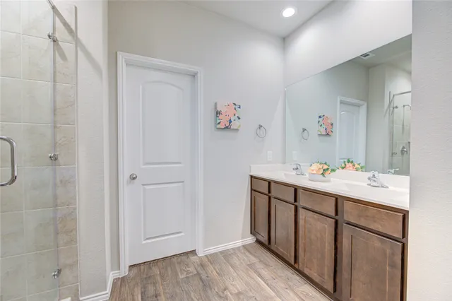 a bathroom with a sink vanity and mirror
