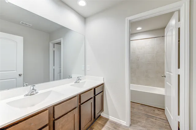 a bathroom with a sink a shower and a mirror