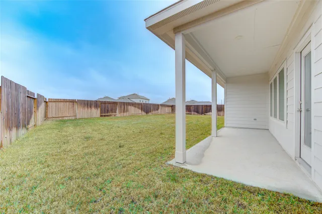 a view of an house with backyard and porch