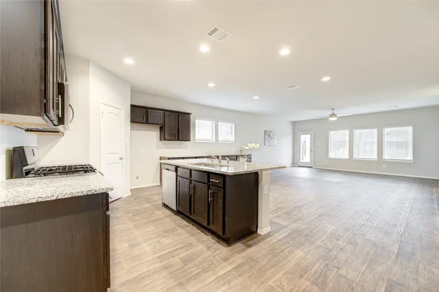 a large kitchen with a stove top oven