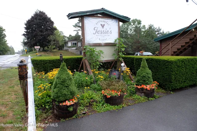 a sign that is sitting in front of flowers