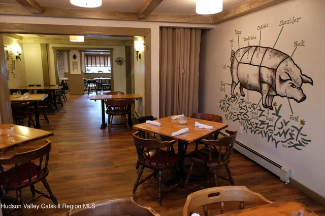 a dining room with furniture and wooden floor