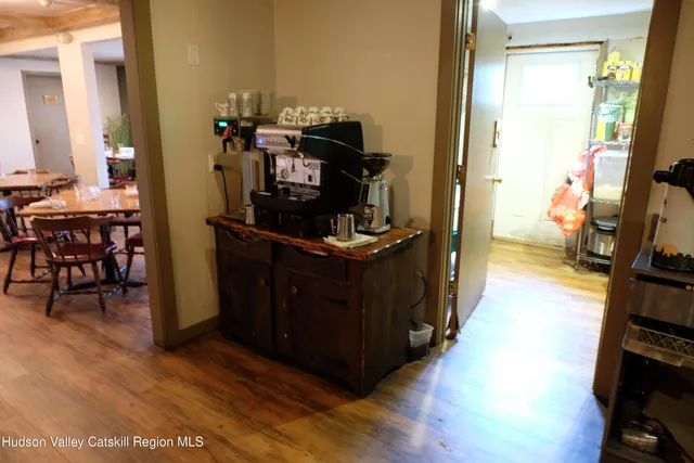a kitchen with a wooden floor and a dining table