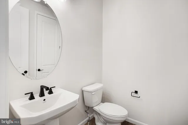 a bathroom with a sink a mirror and a toilet