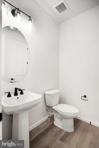 a white toilet sitting next to a bathroom sink