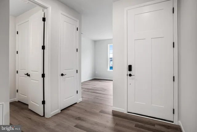 a view of a hallway with wooden floor