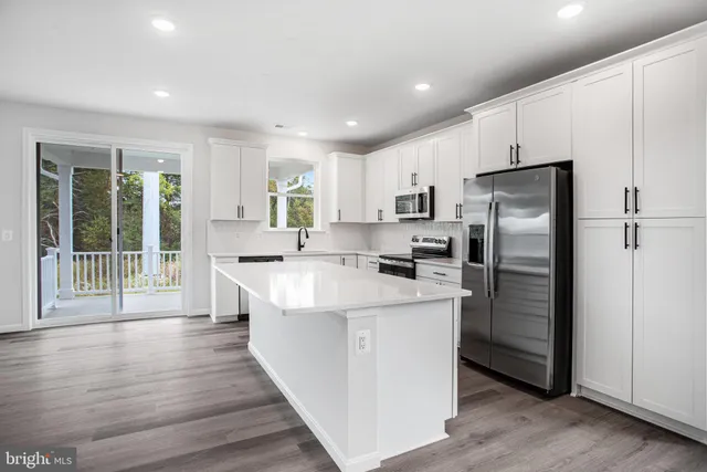 a kitchen with refrigerator and window