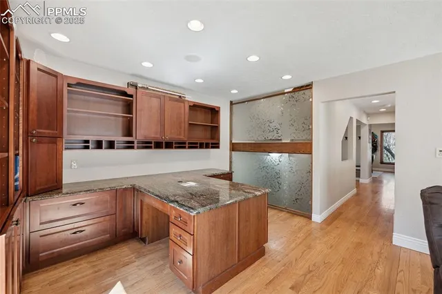 a kitchen with stainless steel appliances granite countertop a stove and a refrigerator